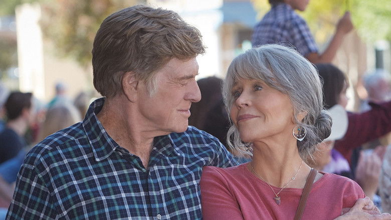 Addie and Louis sharing a quiet, intimate moment, leaning against the kitchen counter, finding comfort in their late-life companionship.