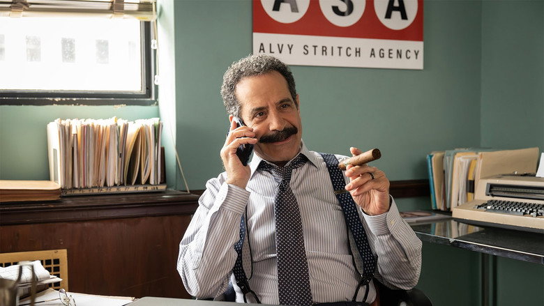 The quiet, shadowed wings of the theater, with Richard Bean sitting alone in the dim light