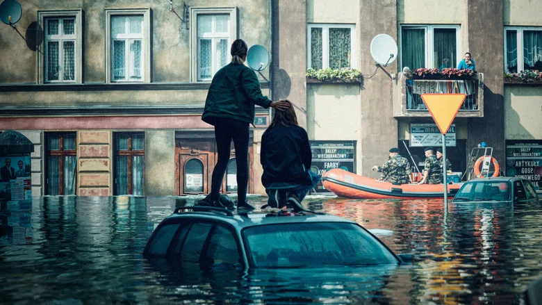 A city official stares at a map of Wrocław, the red lines of the floodplain creeping closer to the heart of the city.