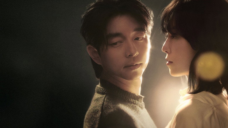 A dimly lit room where Seo Hyun-jin’s character, Ji-eun, sits on the floor, her back against a wall, staring at a small, ornate box—the trunk’s first appearance, half-hidden in shadow.