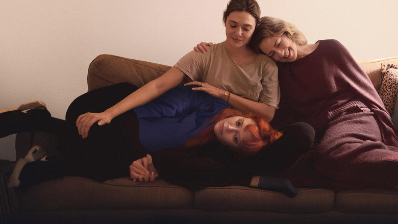 Three sisters sit in a dimly lit apartment, the weight of their shared history pressing down on them.