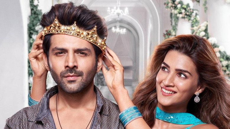 A tense confrontation in a dimly lit room, where Bantu (Kartik Aaryan) stands between his adoptive and biological families, his face caught between anger and confusion.