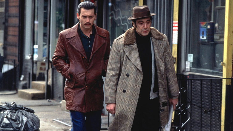 A dimly lit bar, Lefty Ruggiero and Donnie Brasco sitting across from each other, the glow of a neon sign casting long shadows