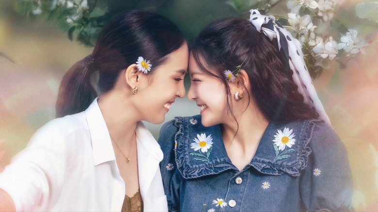 Belle and Lilly standing on opposite sides of a small apartment, arms crossed, glaring at each other with matching stubborn expressions