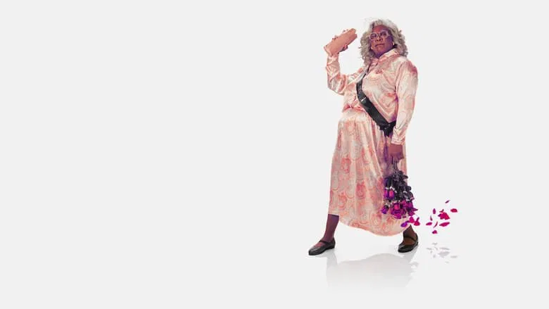 A dimly lit living room where Madea stands with her arms crossed, her expression a mix of exasperation and amusement, as family members argue around her