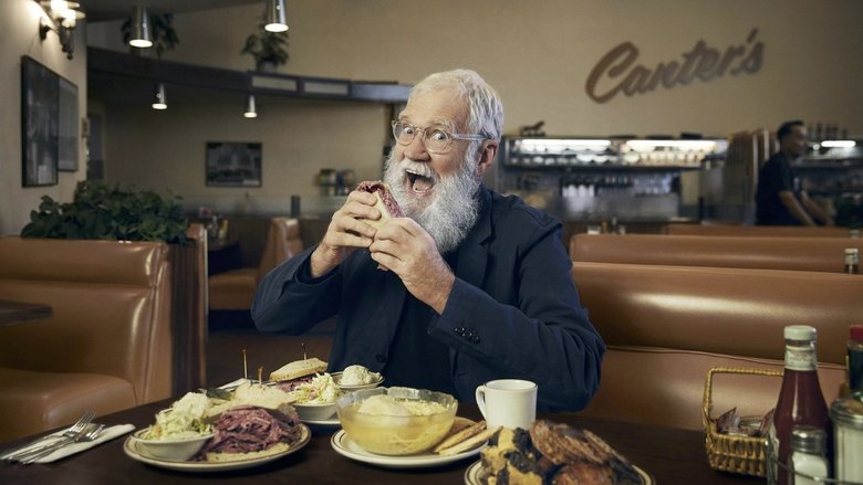 Letterman and Barack Obama sit across from each other in a wood-paneled room, the former president leaning forward with his hands clasped, Letterman’s beard a wild contrast to his relaxed posture.