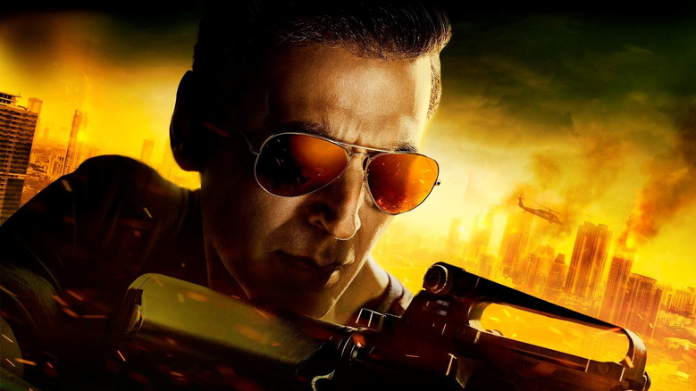 A still from *Sooryavanshi* showing Akshay Kumar in a tense standoff, his face half-lit by the glow of a Mumbai streetlamp