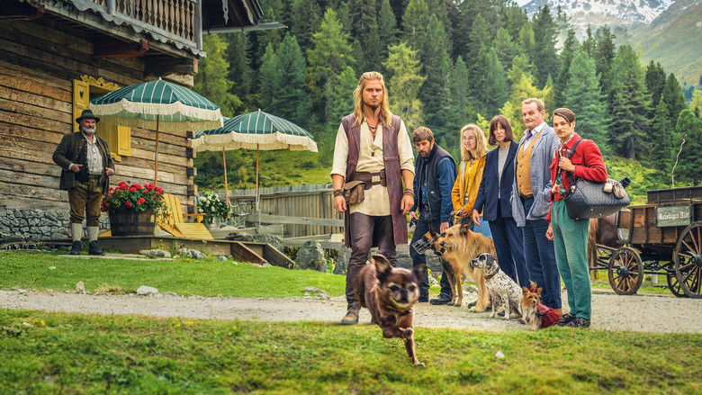 A wide shot of the ensemble cast arriving in the Tyrolean mountains with their dogs