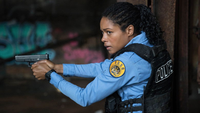 Alicia West, in uniform, standing in the dim glow of a New Orleans street at night, her face half-lit by the neon of a convenience store sign.