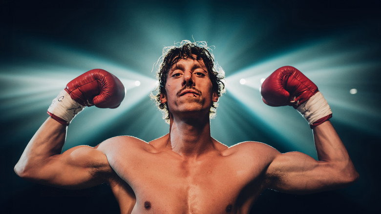 A young boxer mid-punch, his face a mask of determination and sweat, the ropes of the ring blurring in the background.