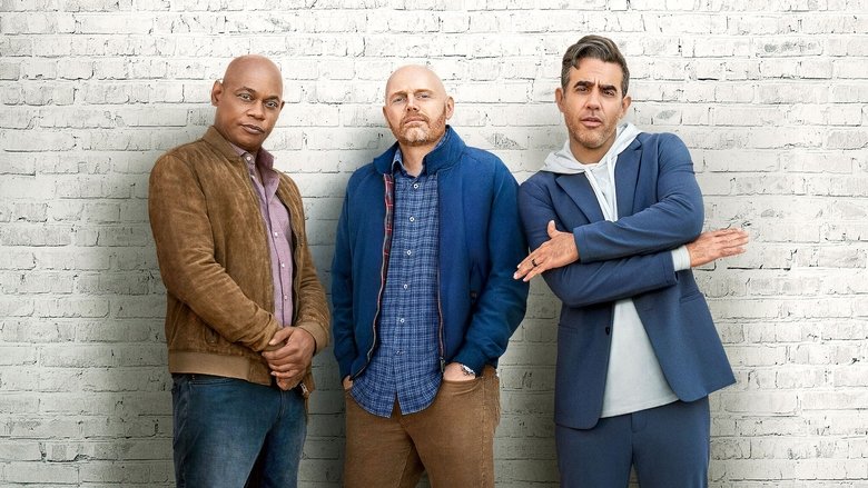 Three middle-aged men sit on a couch, looking exhausted and exasperated, as if they've just survived a minor disaster.