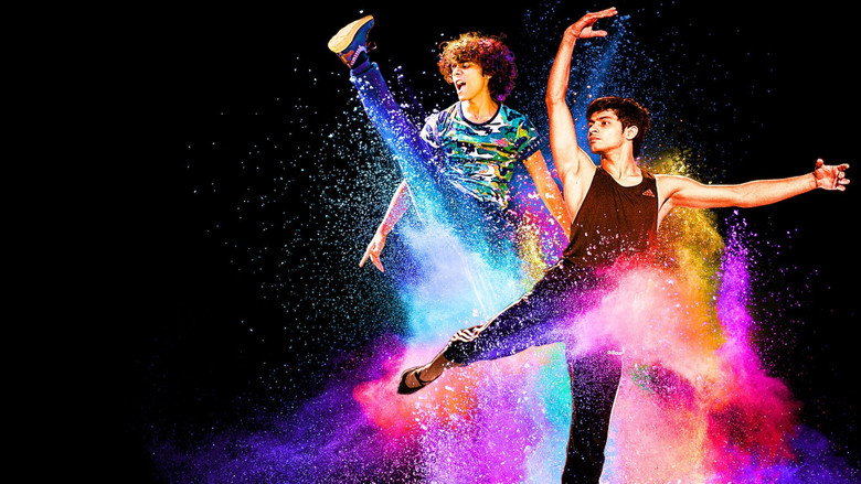 Two young dancers mid-leap in a sunlit studio, their shadows stretching long across the floor