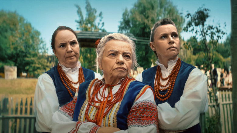 A group of villagers standing in a field at dusk, their faces half-lit by the setting sun, as they stare at a freshly made crop circle.