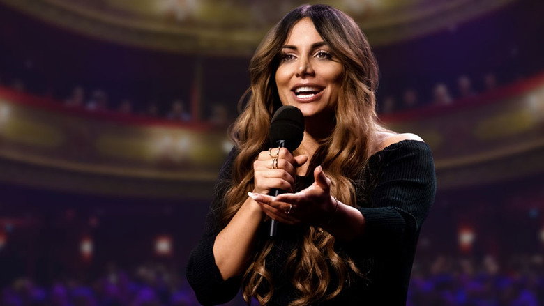 Enissa Amani onstage in Hamburg, microphone in hand, mid-monologue