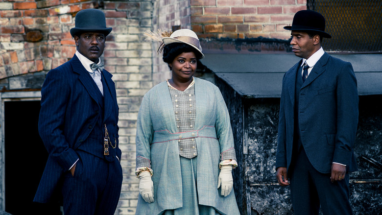 Octavia Spencer as Madam C.J. Walker, standing in a boxing ring with ropes made of hair, her fists raised in a surreal fantasy sequence.
