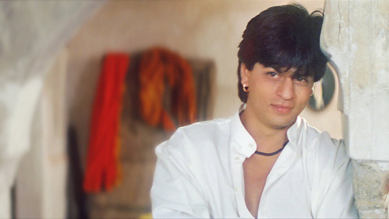 A dimly lit room where Roop sits beside his father, the weight of responsibility etched into his posture.