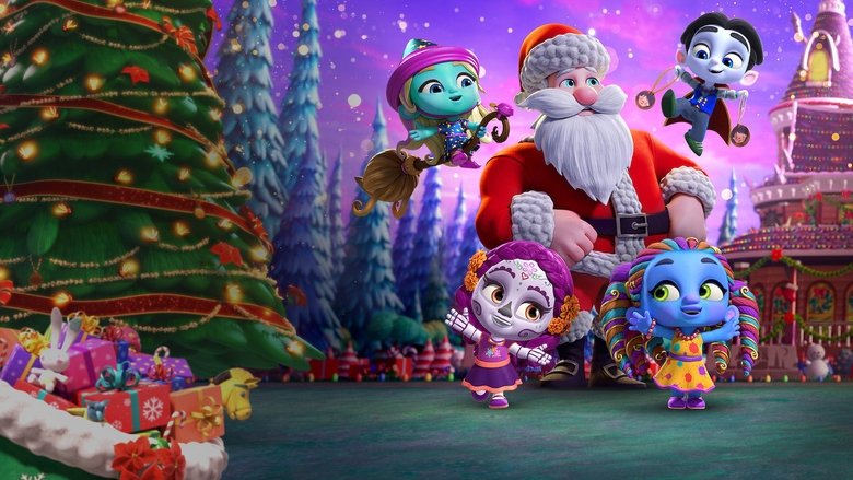 The Super Monsters gather around a glowing Christmas tree, their tiny fangs and fur gleaming under the twinkling lights.