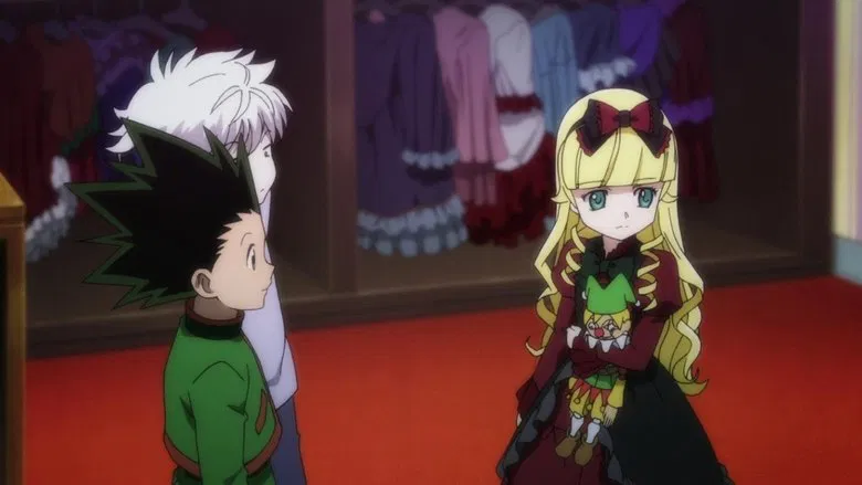 Gon and Killua standing in a surreal, red-tinted landscape, their expressions tense as shadows stretch unnaturally around them