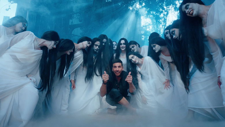 A man in a traditional Indian kurta tiptoes past a group of villagers, his face twisted in exaggerated fear and concentration.