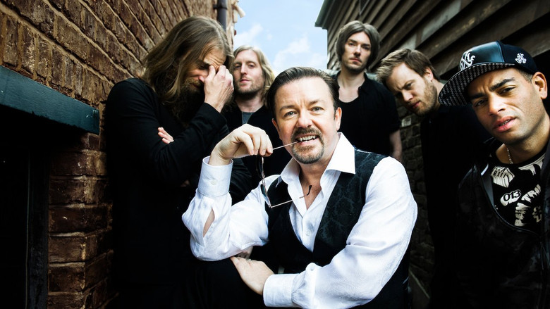 David Brent on stage, guitar in hand, mid-performance, with a look of earnest intensity that borders on delusion.