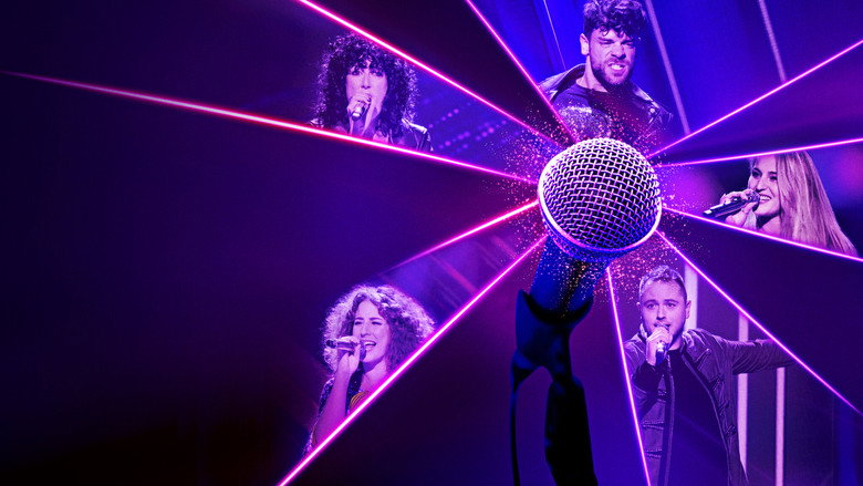 A contestant mid-song, eyes closed, hands gripping the microphone like it's the only thing keeping them upright