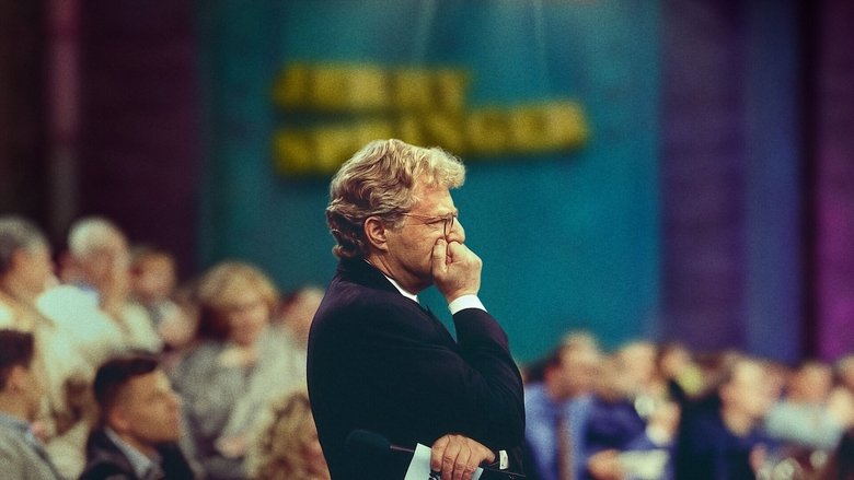 A chaotic studio brawl on *The Jerry Springer Show*, with guests and security tangled in a blur of limbs and flying objects