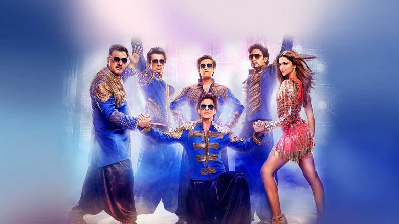 A neon-lit dance sequence in *Happy New Year*, with Shah Rukh Khan at the center of a synchronized crowd, arms raised in unison.