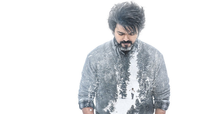 Vijay as Leo Das, standing in a dimly lit room, his face half-shadowed, staring intensely at something off-camera