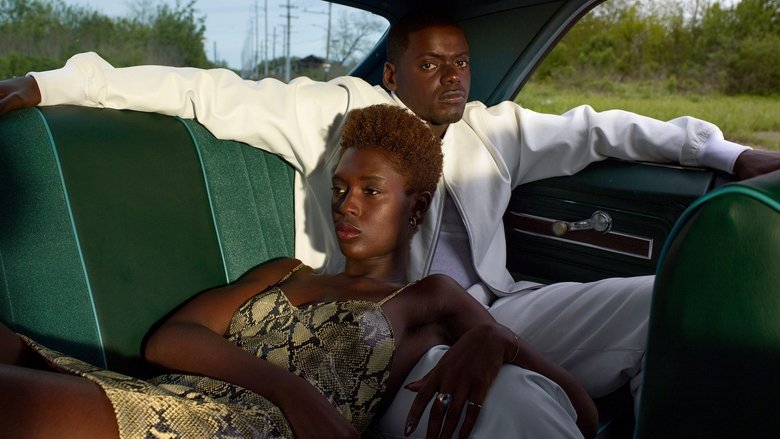 Queen and Slim sitting in a diner, the neon glow of a jukebox casting them in soft, dreamy light.