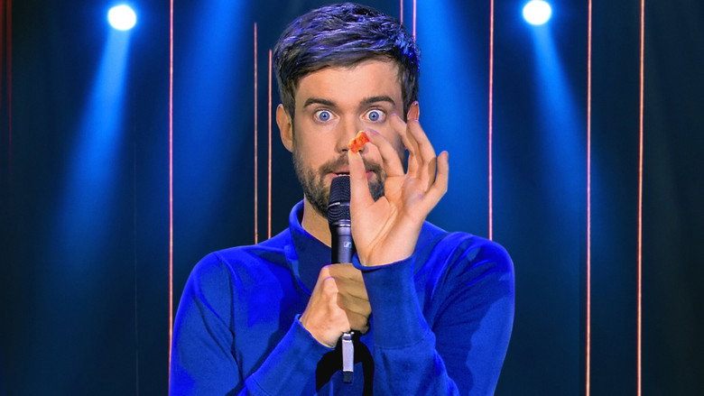 Whitehall on stage at Wembley Arena, bathed in blue light, arms outstretched as if inviting the audience into his world