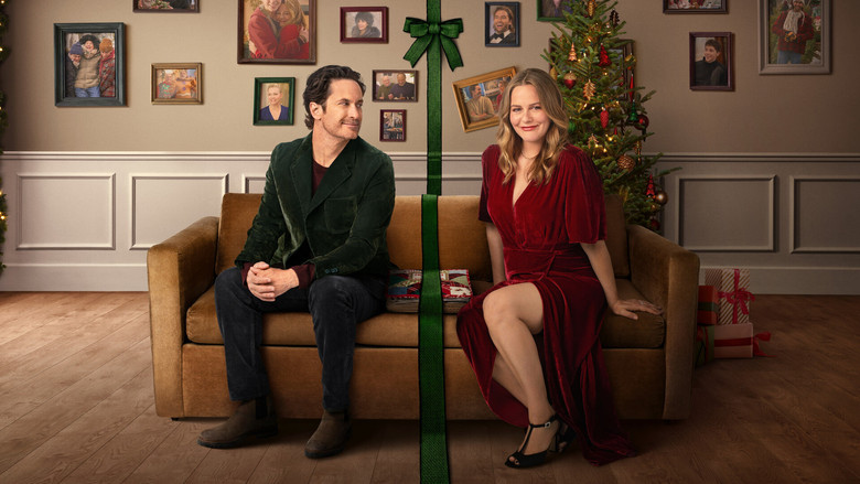 Jameela Jamil smiling awkwardly at a tense holiday dinner table