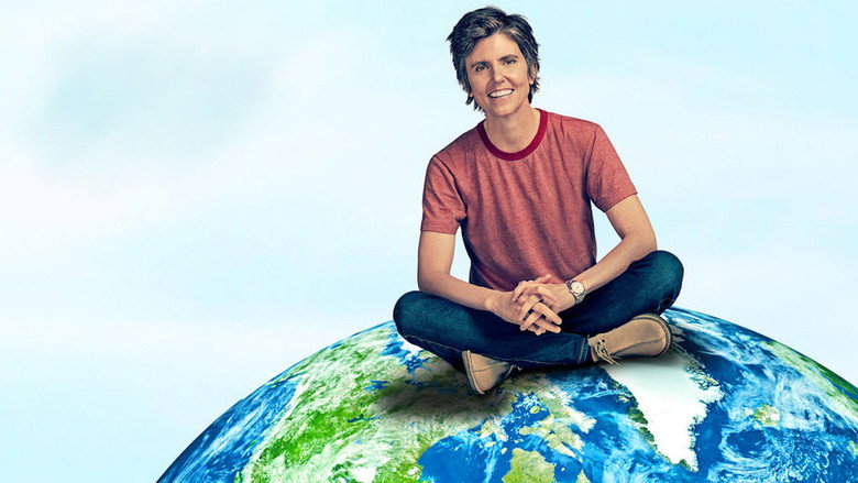 Tig Notaro on stage, mid-performance, her expression deadpan as she delivers a joke