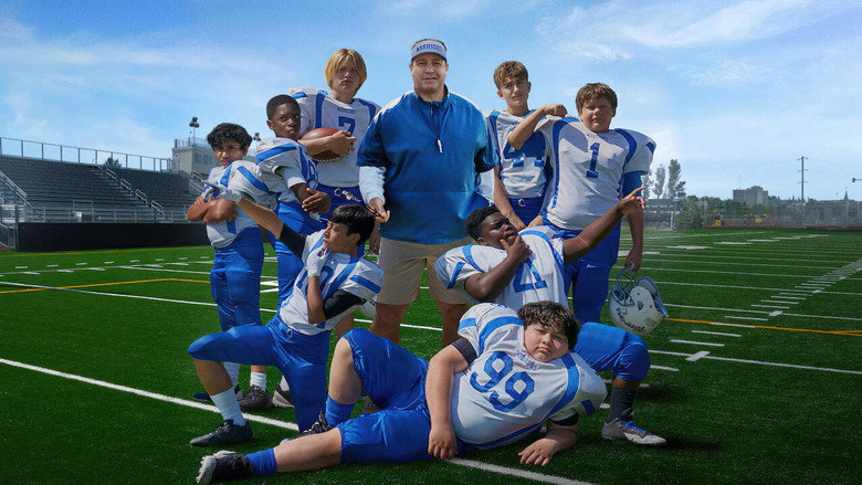 Kevin James as Sean Payton, standing on the sidelines of a youth football game, arms crossed, looking exasperated but determined.
