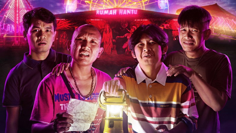 Four friends stand in front of their ramshackle haunted house attraction, their expressions a mix of exhaustion and manic energy.
