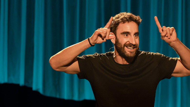 Dani Rovira on stage, mid-gesture, his face lit with a mix of amusement and something deeper