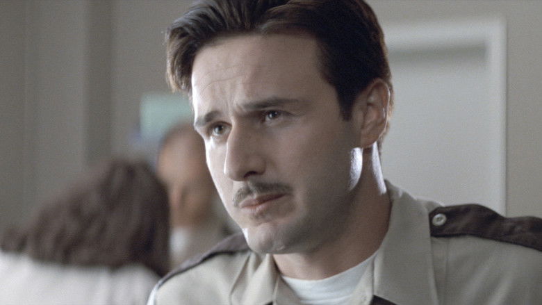 The iconic Ghostface mask looking directly at the camera