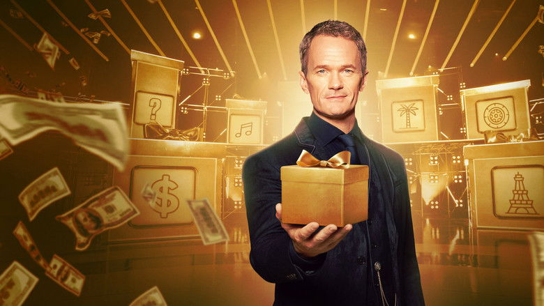 A massive gold mystery box sitting under dramatic studio lights