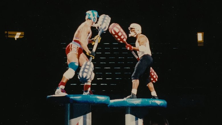 A row of Gladiators in full costume, their faces obscured by helmets, standing in a line under harsh stage lights
