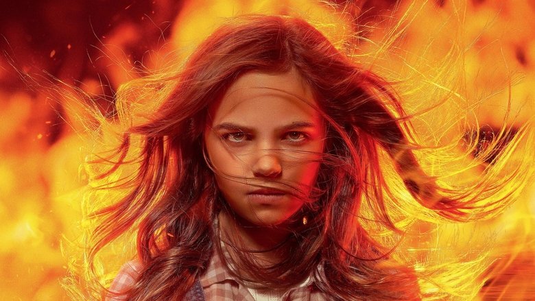 A close-up of Charlie’s face, her eyes glowing with an eerie orange light as flames dance in her irises