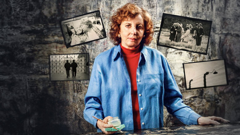 A survivor sits in her kitchen, holding a banana, the weight of memory in her eyes.