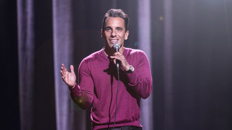 Maniscalco mid-performance, arms outstretched, making a face of exaggerated disbelief