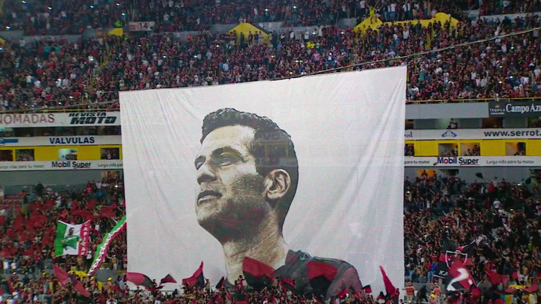 A young Rafael Márquez in an Atlas FC jersey, mid-game, his face set in concentration