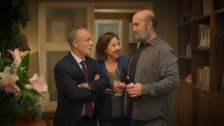 A tense family gathering with the three siblings sitting in a cluttered living room