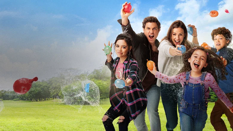 A family in a car, mid-chaos, with water balloons and a look of wild excitement