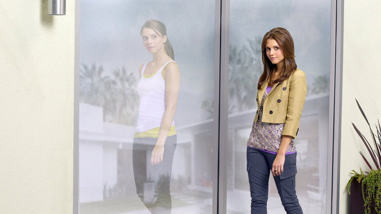 Two sisters stand back-to-back in a dimly lit room, their identical faces half-shadowed, one looking determined, the other hesitant.