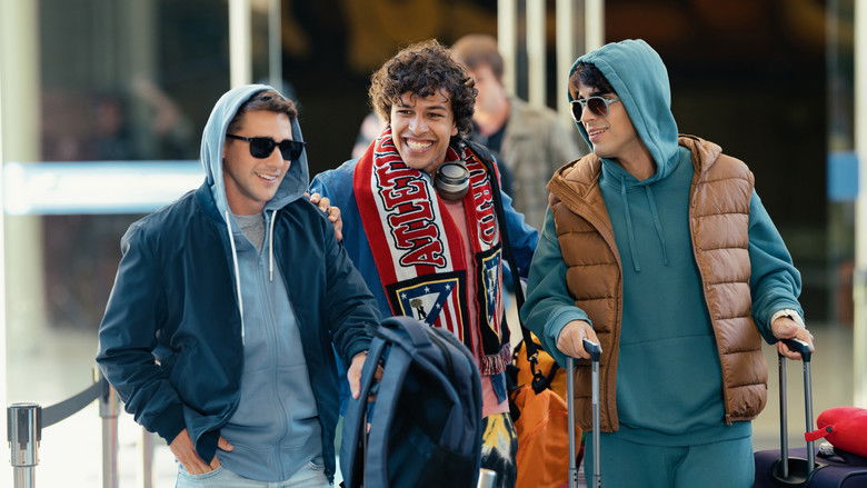 A dramatic, low-angle shot of the team huddled on the pitch during a rainy training session