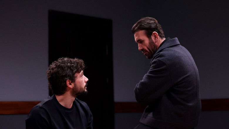 A lone figure framed by the harsh geometry of a concrete cell