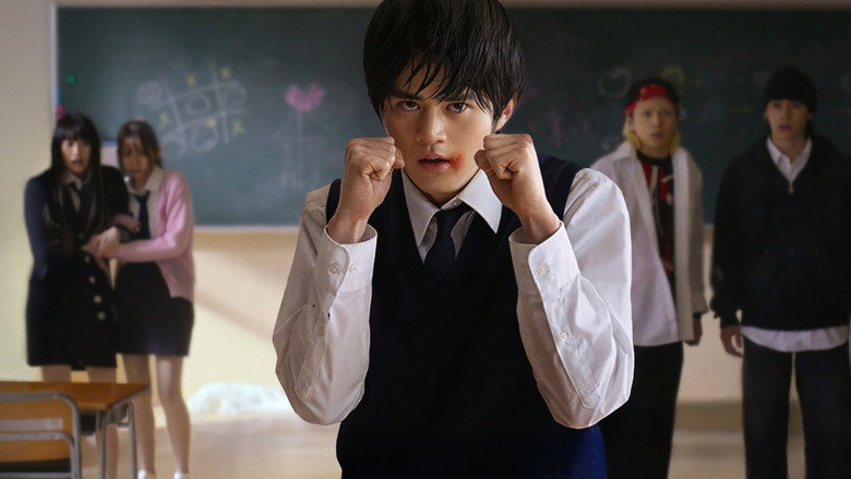 Kota Shimura in white makeup, mid-dance, his expression caught between humiliation and exhaustion
