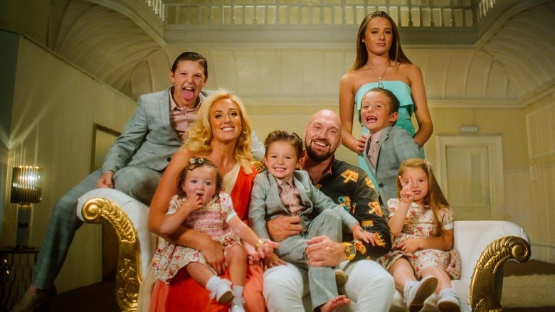 The Fury living room, mid-chaos: kids sprawled on the floor, Tyson in a tracksuit holding a mug, Paris laughing in the background