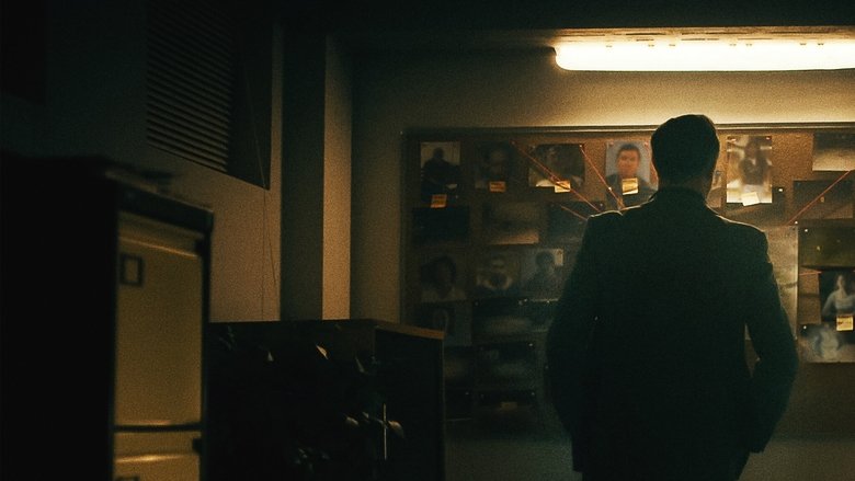 A detective sits in a dimly lit interrogation room, his face half in shadow, staring at a case file.